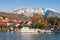 Picturesque winter Mediterranean landscape. Montenegro. View of Marina Kalimanj in Tivat city and  snow-capped mountains of Lovcen