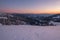 Picturesque winter  morning pre sunrise alps. View of famous Ukrainian Dragobrat ski resort from Svydovets mountain ridge