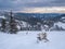 Picturesque winter windy and cloudy morning alps. View of famous Ukrainian Dragobrat ski resort from Svydovets mountain ridge