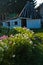 Picturesque wooden house with garden full of flowers at Sjenica