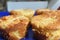 Pie with chesee on a white plate. Sponge cake with black background.