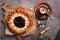 Pie with cottage cheese with strawberry jam, a cup of hot coffee, rustic dark background. Top view, flat lay