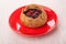 Pie with cowberries in red saucer on table