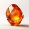 Piece of amber stone, a single amber crystal on white background.