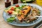 A piece of baked red fish with a side dish of sprouts and avocado salad. Macrobiotic food concept. Healthy food