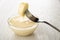 Piece of banana strung on fork on bowl with condensed milk on table