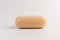 Piece of beige soap  on a white