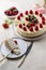 Piece of birthday cake with whole cake on table, fork and knife near