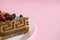 Piece of biscuit patterned cake with blue mastic and decor fruit