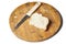 A piece of bread and a knife on a wooden board isolated on a white background