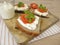 Piece of bread with whipped feta cream and tomato