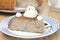 Piece of buckwheat cake (krupenik) with curd cream horizontal