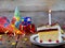 Piece of cake `Napoleon` with lighted candles. Birthday. Side view. Copy space.