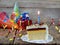 Piece of cake `Napoleon` with lighted candles. Birthday. Side view. Copy space.