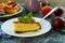 A piece of cake with peaches and plums decorated with a leaf of mint on a plate. Preparing a dissert.