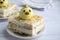 A piece of cake is on a plate. Napoleon cake consists of biscite and ice cream. The cake is decorated with ice cream in the form o