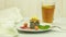 A piece of cake on a white plate and decorated with fruits and sauces