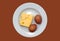 Piece of cheese and two eggs in a plate