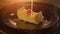 Piece of cheesecake pour a thin stream of sweet cream sauce,