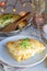 Piece of cheesy scalloped potatoes or potato gratin on a plate,