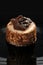 A piece of chocolate cake on a dark background, close-up