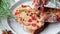 Piece of Christmas fruit cake on a plate in festive decorations