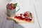 Piece of Clafoutis cherry pie, mug with cherries on gray wooden background