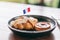 A piece of croissant and tart with a flag of France