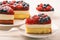 Piece of delicious cheesecake with berry jelly and berries.