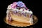 A piece of a delicious, frosted birthday cake featuring a decorative design and pastel colors