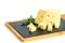 Piece of emmental cheese and rosemary on the black tapas board. Calcium healthy food for snack