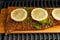 A piece of fish steak with lemons lies on a wooden board, baked, closeup