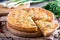 A piece of French quiche Lorraine on wooden background