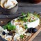 A piece of fresh feta cheese paneer with olives, herbs, spices and slices of flatbread tortilla, lavash, pitta, chapatti