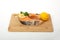 A piece of fresh raw salmon fish with lemon isolated on a wooden base
