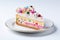 A piece of a frosted birthday cake with a decorative design and pastel colors