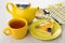 Piece of fruit pie in saucer, teapot, napkin, teaspoon, tea