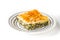 Piece of Greek pie spanakopita on the ceramic plate on the white background