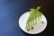 Piece of green tea crape cake on white plate and decorated with