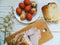 a piece of grilled meat, eggs, Easter flowers and chestnut on a white table