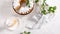 Piece of Homemade apple cake with cinnamon, white icing and flowering apple branches on white background. Pastry. Festive food.