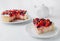 A piece of homemade curd berry pie. Garnished with cream and berries of strawberries, blueberries and sea buckthorn. On a white