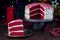 Piece of homemade red velvet cake with cream cheese frosting on metal plate, low key photo with boke lights and christmas