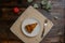 Piece of homemade traditional cornish apple pie on a white plate with a fork on a napkin. Apple and a branch with leaves