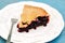 A piece of juicy black currant pie