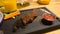 Piece of medium-roasted beef served on a black wooden Board in cafe.