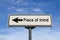 Piece of mind white road sign with arrow, arrow on blue sky background