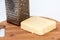 Piece of mozzarella cheese and metal grater on a kitchen wooden