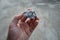 A piece of pegmatite granite rock specimen in a hand.