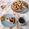 Piece of pie on plate with cup of tea on white table. Breakfast with tea and cake. Food photography. Table top photo. Tea time